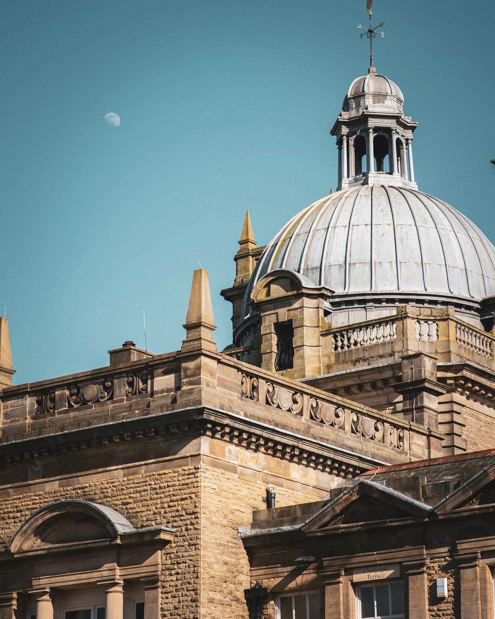 The stone dome and cupola of the Royal Baths in Harrogate against a clear blue sky