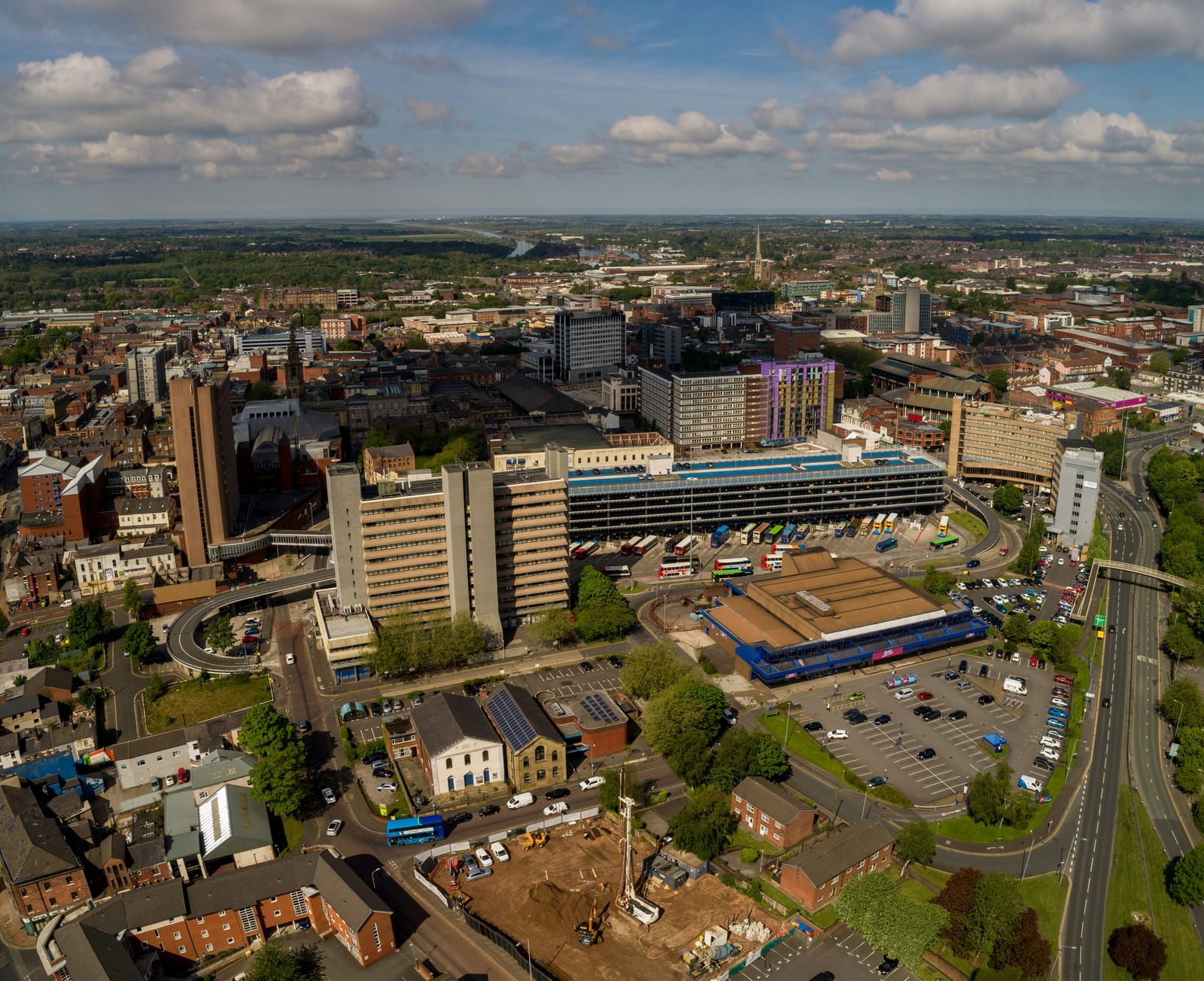 An aerial view over Preston city centre, the River Ribble beyond it